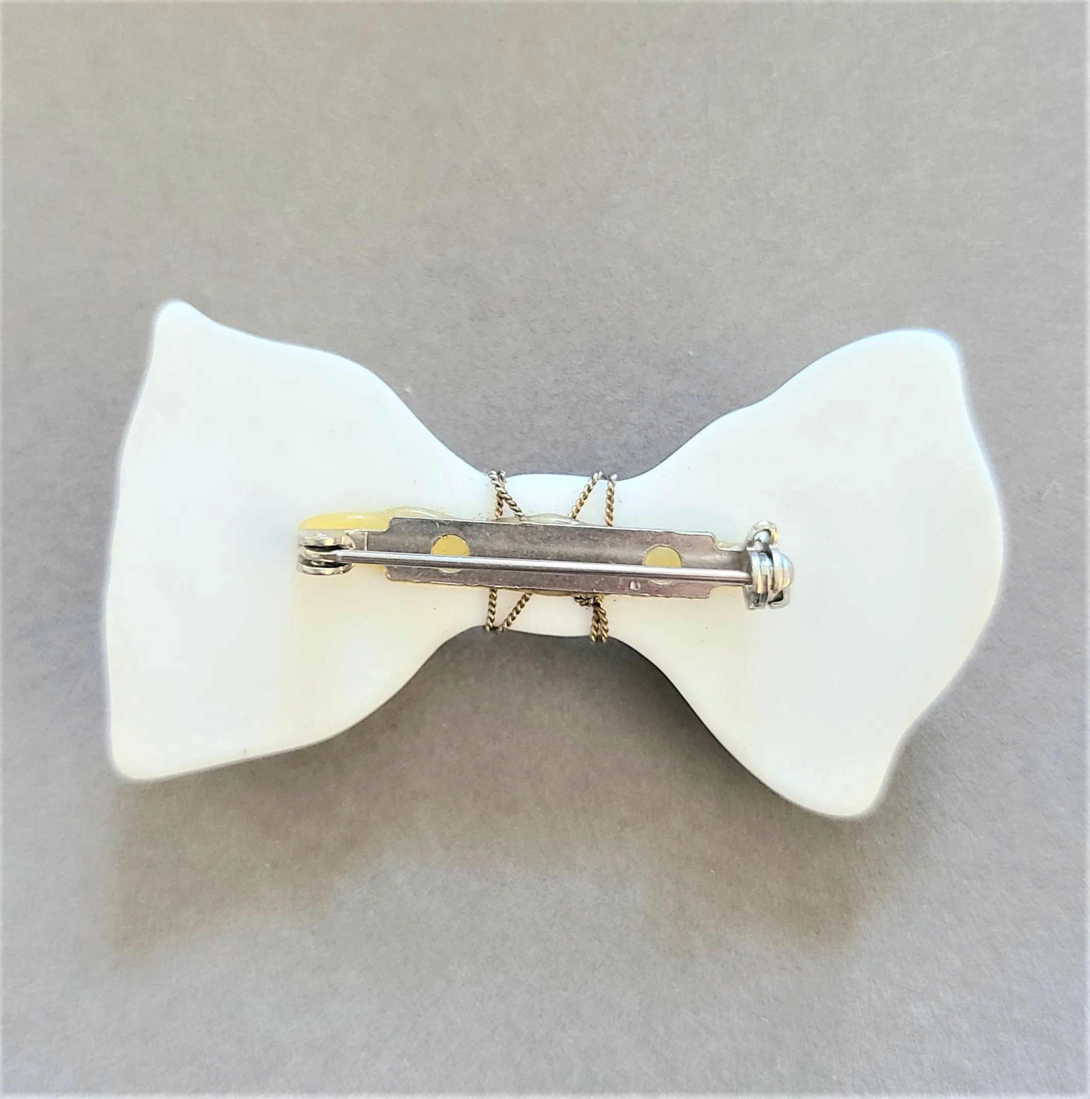White Plastic Bow Pin with Enameled Flowers